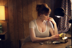 Something tells me Christina Hendricks doesn’t sit waiting by the phone for very long. The white tee over a black bra might be a reason why.