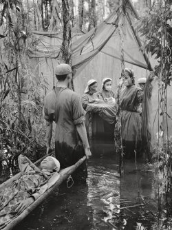 firsttimeuser:  A Cambodian guerrilla is carried to an improvised operating room in a mangrove swamp in this Viet Cong haven on the Ca Mau Peninsula, 1970 photo by Vo Anh Khanh 