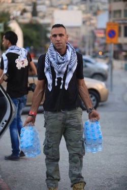 frompalestinewithlove:Palestinian Christians distribute water to  Palestinian Muslims who can’t make it home in time for Iftar because of Israeli checkpoints.