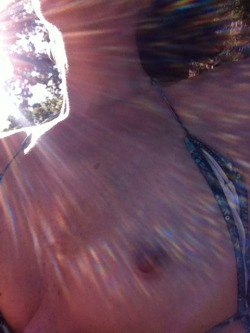 deviousstaresinmydirection:  Sunbathing (and flashing) at the river #2  Awesome picture!  Love the light effects