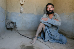 letswakeupworld:  A man who has been deemed insane is seen chained to a wall during his forty-day incarceration in a room at the Mia Ali Baba Shrine in Jalalabad, Afghanistan.  It is believed that forty days in chains and a restricted diet can cure the