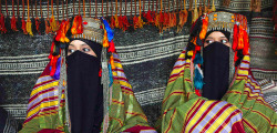kaafla:  Bedouin women wear traditional costumes as they sit in their tent during the Sanaa Summer Festival. The Bedouin are a part of a predominantly desert-dwelling Arabian ethnic group traditionally divided into tribes, or clans, known in Arabic as