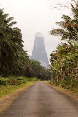 Giant in the mist (the 1000-foot Pico Cão Grande, a volcanic plug peak in Obo National Park, São Tomé Island off the western equatorial coast of South Africa)