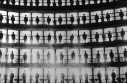 congenitaldisease:  Panopticon Prison: Inmates standing in their cells, Cuba, 1926 -In this eerie photograph of a Cuban prison, inmate after inmate stands silhouetted in a semicircle of stacked cells. They are posed there, backlit, perhaps to demonstrate