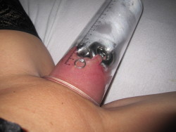 A pierced pussy being well pumped. There is even a scale on the tube so that progress can be monitored.