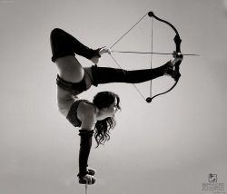 weallheartonedirection:  PsBattle: Girl doing a handstand, holding a bow with her legs