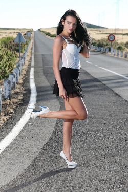greatlegsandhighheels:  Street style stork legging it in a white bustier top with short black frilly skirt and stylish pumps. Nice legs. 