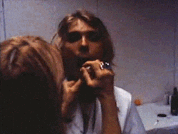 needforcolorbis:   Kim Gordon putting lipstick on Kurt Cobain in 1991: The Year Punk Broke by Dave Markey  