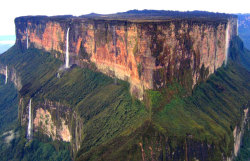 sixpenceee:  Mount Roraima, South America: This tabletop mountain is one of the oldest mountains on Earth, dating back two billion years when the land was lifted high above the ground by tectonic activity. The sides of the mountain are sheer vertical