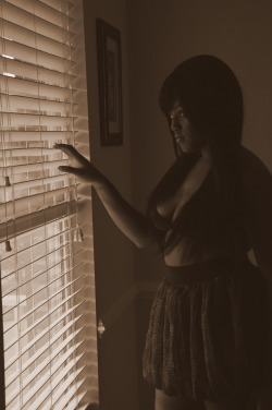 CuteJ peeks out the blinds in this pretty sepia photo.