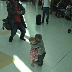  They had never met before, but decided to hug it out in the middle of an airport terminal. 