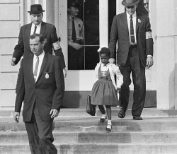 twistedwreck:  gravihty:  wendyss:  Ruby Bridges, the first African-American child to attend an all-white elementary school in the American South, escorted by U.S. Marshals dispatched by President Eisenhower for her safety. 14 November, 1960  this is
