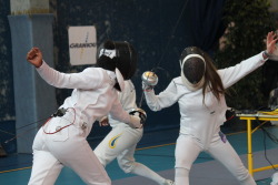 modernfencing:  [ID: two epee fencers in a bout. The fencer on the left is fleching and hitting around her opponent’s parry.] ohyeahfencing:  Arras, France, May 2014, Junior national championship  