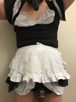 show-us-your-locked-cock:Sissy is grateful to be permitted to wear a dildo gag, maid uniform, and butt plug with their permanently locked tiny cage.