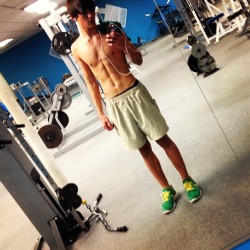 just-a-twink:  03-07-2013:  💛💚💙💜  Shirtless Cutie in the Weights Room… Love the Green Kicks… :) 
