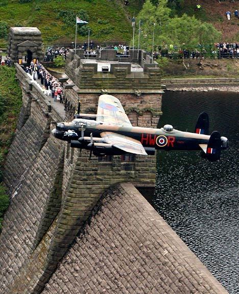 bmachine:  An Avro Lancaster bomber flies at low altitude over a Village dam, England 2008.The flight was timed to coincide with the 65th anniversary of the successful destruction Of the British Royal air force dams in the Ruhr basin. It was on the dam