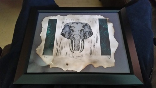 Printmaking papr burned with lighter, Printmaking from linoleum block of elephant head, then watercolor paint to give it a little extra detail with color,it’s a gift for my grandmother!!!!