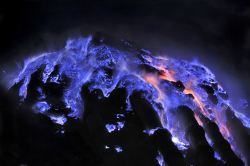decemberpaladin:  fotisha:   The Kawah Ijen volcano in East Indonesia produces molten sulphur from vents in its sides, which appear bright red during the day but glow blue by night.  Idk if I’m the last one to see this, but have you guys seen this volcano
