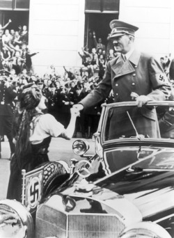 fuehrerbefehl:  Hitler greeting a beautiful German woman as he passes by. 