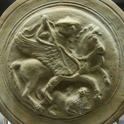 lionofchaeronea:Bellerophon, astride Pegasus, attacks the Chimera.  Molded medallion from an Apulian terracotta flask, artist unknown; ca. 300-250 BCE.  Now in the British Museum.
