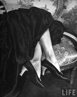 onlyoldphotography:  Nina Leen: Rhinestone heels, imported from France, being worn on plain black satin opera pumps. 1949 