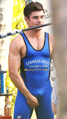 Zac Efron bulges in a wrestling singlet for “Mike and Dave Need Wedding Dates”