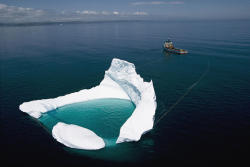 visitheworld:  Ship towing an iceberg off the shore of Newfoundland / Canada (via theamazingpics),