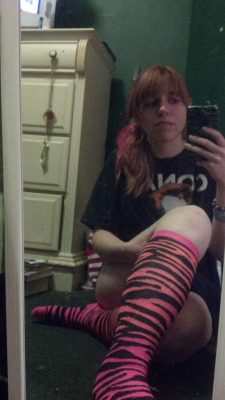 Pennylaine snaps a photo in her pink tiger striped knee highs.