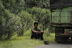 Man waits for help next to his broken truck. Bandung, Indonesia