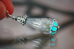 wickedclothes:  Glow In The Dark Dandelion Necklace Visible during the day or night, this glass vial holds several dandelion seeds. The bottom of the glass vial holds a glow in the dark accent which glows bright blue for up to nine hours. Sold on Etsy.