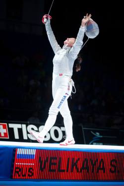 modernfencing:  [ID: a sabre fencer on strip with her arms in the air in celebration.] Sofiya Velikaya at the 2015 World Championships after winning women’s team sabre! 