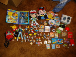 pyroluminescence:   pacificpikachu:   My Ash and Misty collections, plus a few other cameos from other characters. This doesn’t include all my cels and flat items, just what goes on the shelf. The two big Ash plushes are both bootlegs, but…fairly
