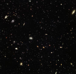 ohstarstuff:  Hubble peers billions of light years away, uncovering thousands of colorful galaxies clustered together in the constellation of Leo (The Lion). Galaxy clusters are so massive that their immense gravity warps and amplifies the light from