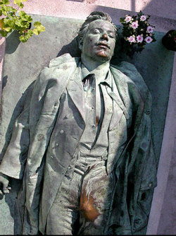 the-chubby-nerd: sixpenceee:  Victor Noir is more famous for his death and his grave than for his life. He was a journalist who was shot dead. To mark his grave, a bronze statue of the man lying down as if just shot was erected. This statue has since