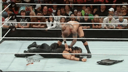 Randy Orton violent stripping Roman Reigns. He must really hate those vests!