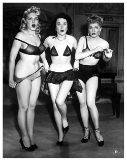 burleskateer:     COSTUME ADJUSTMENTS.. Jennie Lee (at Left) is featured with good friends: Pat Flannery (middle) and Doreen Gray, in a publicity photo for the 1951 Burlesque film: “DING-DONG! A NIGHT in the MOULIN ROUGE”.. It was a documentary-style
