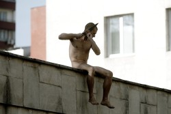 nyctaeus:  Artist Petr Pavlensky climbed naked onto the wall of Moscow’s Serbsky psychiatry centre and swiftly sliced off his right earlobe. The Russian artist stayed there, bleeding in the cold, completely silent and still for two hours. He was