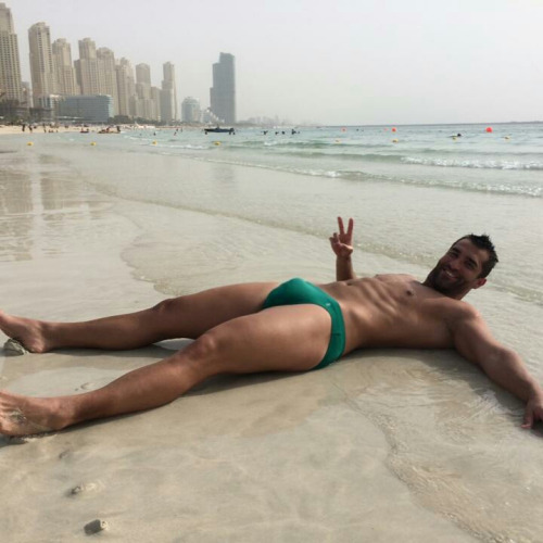 stratisxx:This Egyptian stud has it all… Tall… Dark…. Huge fat hairy cock…look at those bulging speedos. My friend sent me these pics… He’s a hot blond young twink. He said that this Egyptian stud aggressively hit on him at the beach… Took