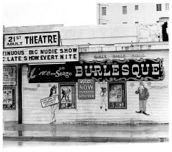 Vintage candid photo from September of 1969 features a rainy afternoon at the ‘21st ADULT Theatre’; located on Collins Avenue (at 21st Street) in Miami Beach, Florida.. Despite it&rsquo;s rather seamy appearance, small signs still encouraged husbands
