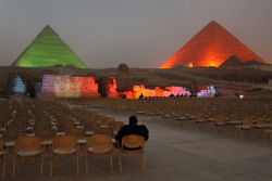 xne:   An Egyptian visitor watches a nearly empty light and sound