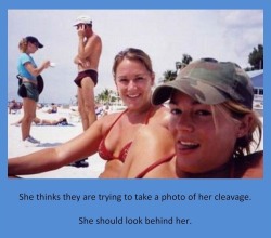 She thinks they are trying to take a photo of her cleavage.She should look behind her.