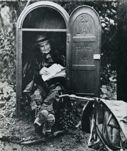 An ingenious postman in Idaho takes refuge from the rain in a mail storage box.
