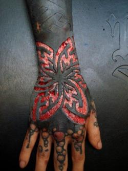 fresh scarification on black tattoo