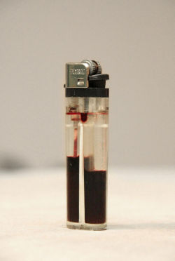 truneet:  Ernesto Bautista - Masses [Masas], 2009 Transparent lighter filled with blood 