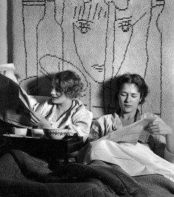 lapitiedangereuse:  Lee Miller and Tanja Ramm having breakfast in bed at Lee’s Paris studio, 1931. The wall hanging is from a Jean Cocteau design. 