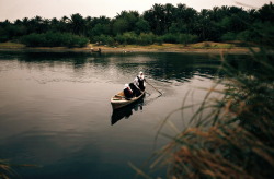 aliirq:    Iraqi school girls paddle a small wooden boat across a river, as they head to school. 2015, Najaf, Iraq. © Haider Hamdani 