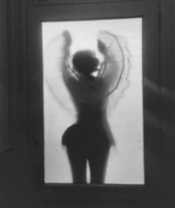 Girl in crinoline skirt through frosted glass 1950s