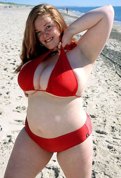   A fat woman in a red bikini at the beach