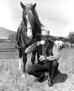 oldhollywoodfilms:  John Wayne takes a coffee break on the set of Tall in the Saddle (1944).