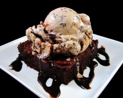 fyeahsundaes:  Bittersweet Brownie a la Mode: A Cappuccino Brownie topped with a generous scoop of Coffee Ice Cream that has been swirled with Bittersweet Fudge, Chocolate Chunks and then covered with a Dark Chocolate Sauce. 